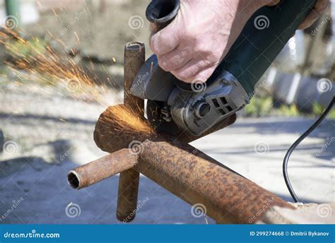 Male Hands Hold A Working Power Tool For Cutting Metal Stock Photo