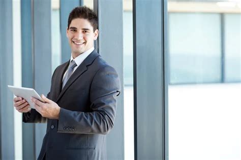 Happy Young Businessman With Tablet Computer In Office Stock Image