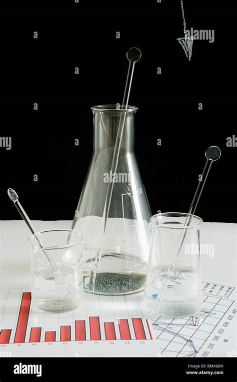 Flask And Beakers On Graphs Stock Photo Alamy