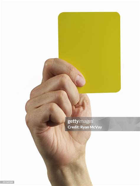 Hand Holding Soccer Yellow Card High Res Stock Photo Getty Images