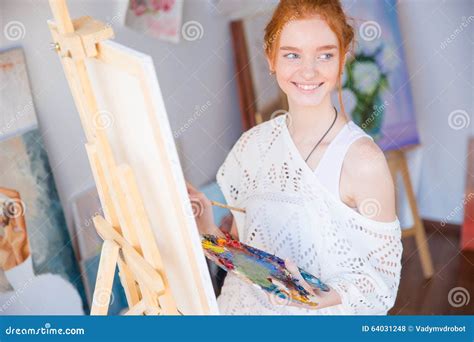 Woman Painter Holding Palette With Oil Paints In Art Studio Stock Photo