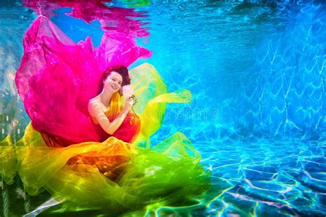 Girl In A Beautiful Dress Under Blue Water Female Model Posing Under Water In Swimming Pool