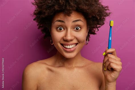 Positive Afro American Woman Tells Step By Step Instruction How To Brush Your Teeth Correctly