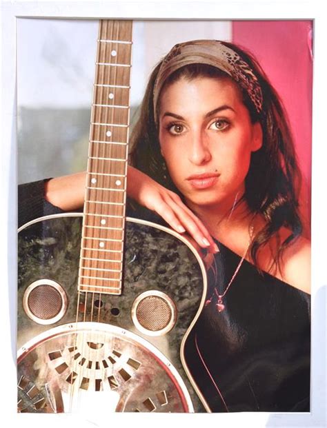 Amy Winehouse A Colour Photographic Print Of Amy Posing With A Guitar