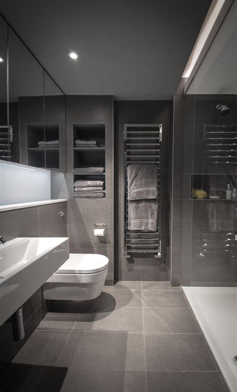 Grey Ensuite Bathroom With Concealed Sliding Mirror Door And Walk In