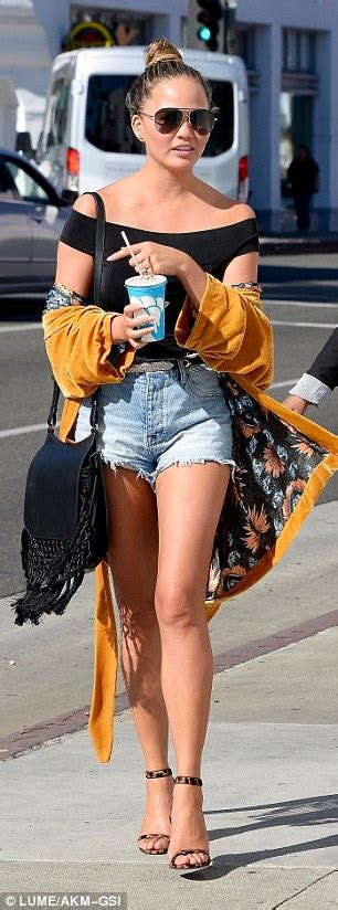 Chrissy Teigen Flaunts Her Figure In Tiny Cutoffs And Off The Shoulder Top In Beverly Hills