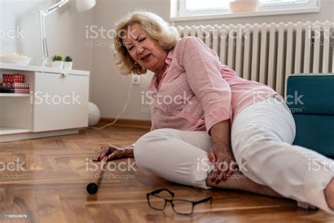helpless retired woman with blonde hair sitting on floor at homethe risks that come with getting