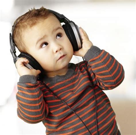 13485840 Young Kid Wearing Headphones And Listening To Music Indoor