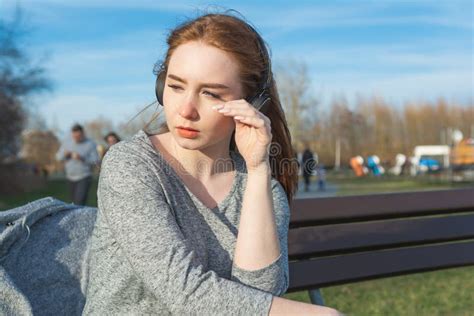 Young Sad Cry Redhead Girl In The Spring In The Park Near The River