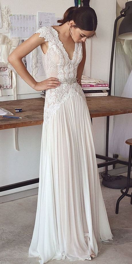 Featuring a bateau neck, dropped waist and full skirt with train. Best wedding dress designers 2018