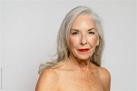 Mature Woman Poses With Bare Shoulders By Stocksy Contributor