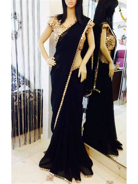 This plain black saree with border is with a beige and gold heavy embroidered blouse. Black Georgette Saree with Real mirror work and Real ...