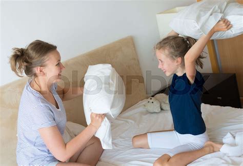 Mother And Daughter Fighting By Pillows Stock Image Colourbox