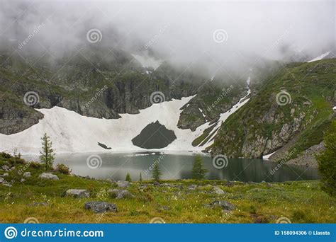 A Beautiful Mountain Lake Of Turquoise Color Snow Is Reflected In The