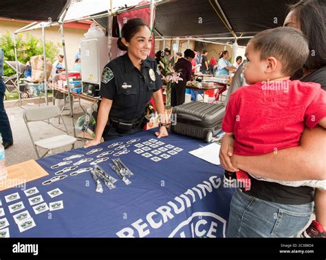 female hispanic police officer at a recruiting booth for the austin police department at a