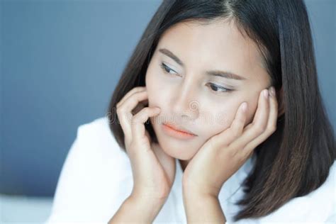 Closeup Woman Sitting On Bed In The Bedroom With Thinking Or Depressed