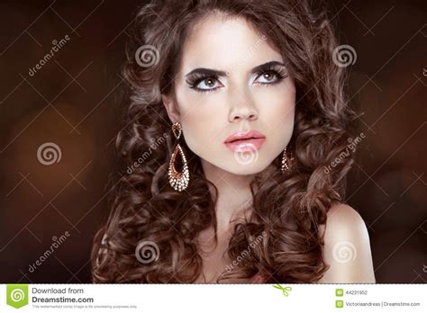 Having long hair opens up your styling. Beautiful Girl Model With Curly Long Hair And Fashion Earrings Stock Photo - Image of close ...