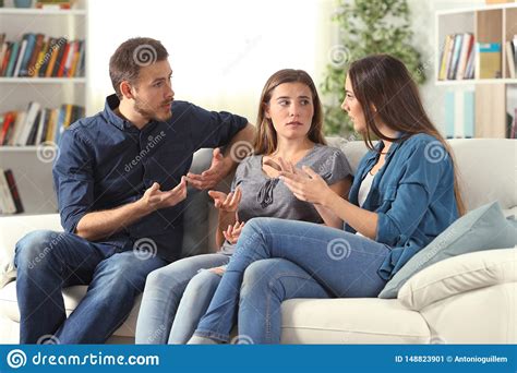Three Serious Friends Talking Sitting On A Couch At Home Stock Image