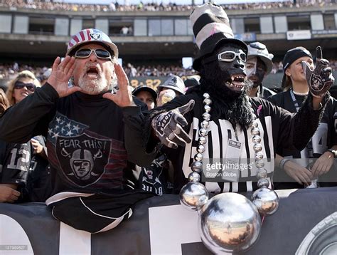 Oakland Raiders Fans In The Famed Black Hole Section Of The End