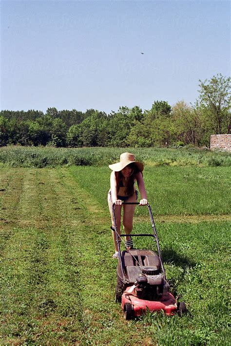 Young Woman Mowing Grass By Stocksy Contributor Marija Strajnic