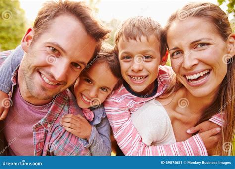 Young Kids Hugging Parents Outdoors Close Up Portrait Stock Photo