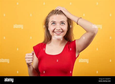Young Blonde Girl In Red T Shirt Over Isolated Orange Background Shows