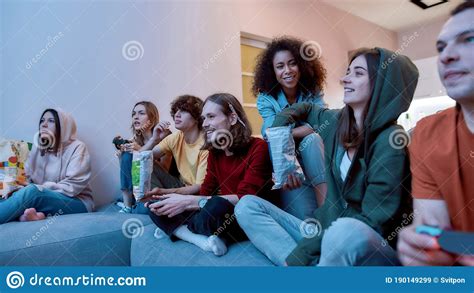 Having Fun Young Multicultural People Playing Video Games Eating
