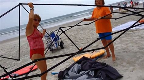 Two Inept Thieves Who Are Caught Stealing Beach Canopy On Camera Try To