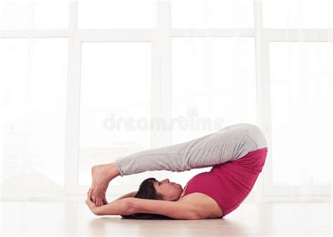 Slim Yogini Lying On The Back On The Mat In A Yoga Position Legs Stock