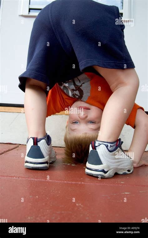 Small Child Looking Through Legs Upside Down Playing Stock Photo Alamy