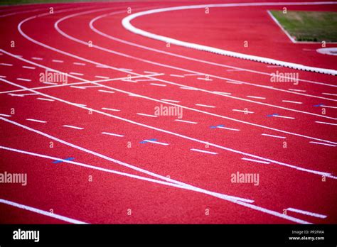 Red Rubber Running Racetrack With White Lines In Outdoor Stadium Stock
