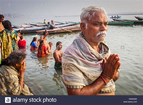 pilgrims praying and bathing in the ghats of ganges river varanasi uttar pradesh india stock