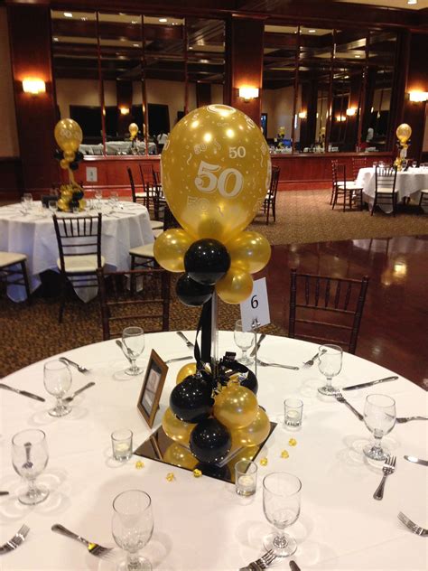 Look at this simple but elegant decoration. Black and gold balloon centerpieces for a 50th birthday or ...