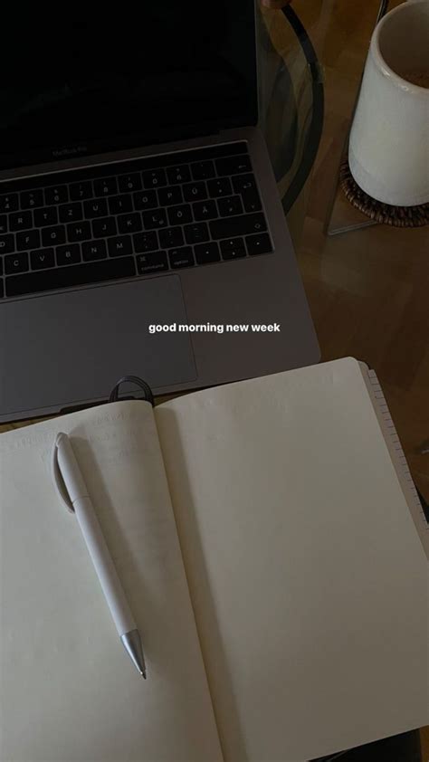 An Open Notebook Sitting On Top Of A Table Next To A Laptop Computer