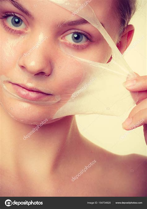 Woman Removing Facial Peel Off Mask Stock Photo By ©voyagerix 154734920