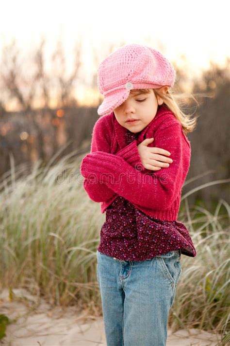 Young Girl Shivering In The Countryside Stock Photo