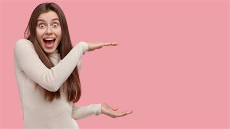 Free Photo Overjoyed Attractive Woman Shows Size Of Something Big