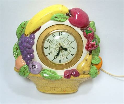 A Clock Made Out Of Fruit And Vegetables On A White Surface With A Cord