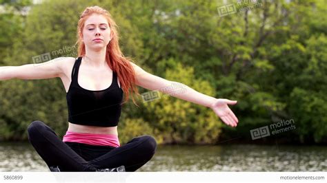 Calm Redhead Doing Yoga By A Lake Stock Video Footage 5860899