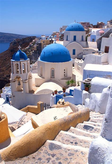The Iconic Blue Domed Churches Of Oia Village On The Greek Island Of