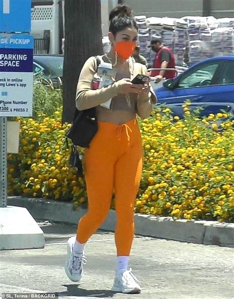 Vanessa Hudgens Stands Out In Bright Orange Leggings And Matching Mask While Out And About In La