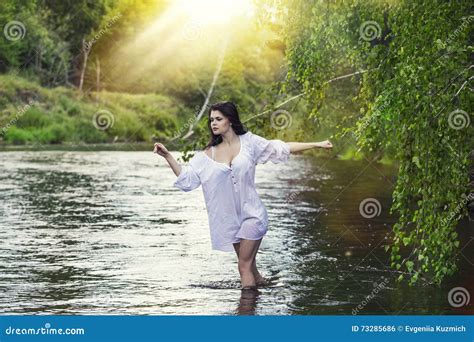 Young Beautiful Woman Enjoys The Lake With Turquoise Clear Water Stock