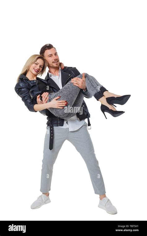 A Man Is Holding A Woman In His Arms Smiling Couple Front View The Guy Is Wearing His