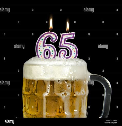 Lit Birthday Candles In Mug Of Beer For 65th Birthday Isolated On Black