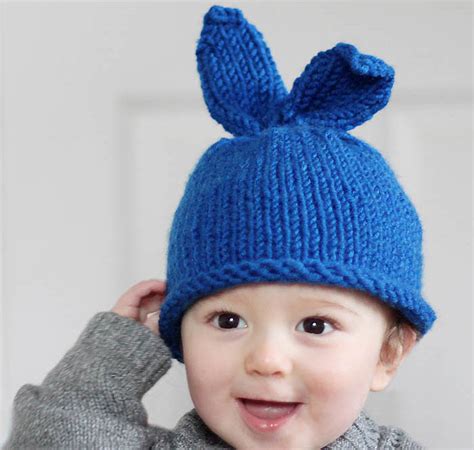 Want a comfy winter baby hat that should cover the baby's ear too? Baby Bunny Rabbit Hat Knitting Pattern - Gina Michele