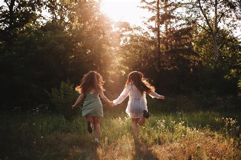 Back View Of Girlfriends Holding Hands While Running In Summer Forest Photograph By Cavan Images
