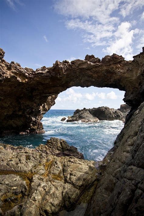 Waves Roll In Under A Natural Bridge Southern Coast Of Aruba