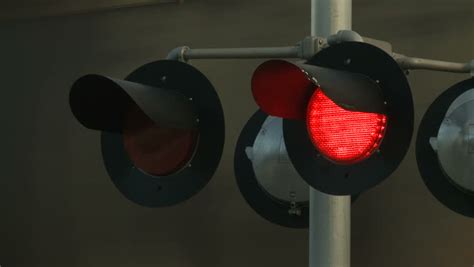 Flashing Red Warning Lights Operating At A Railway Level Crossing To