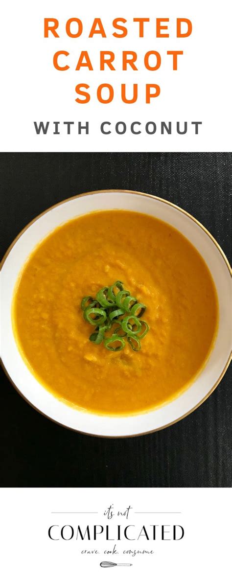 Roasted Carrot Soup With Coconut In A White Bowl On A Black Tablecloth