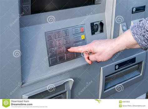 Close Up Of Hand Entering Pin At An ATM. Female Arms, ATM - Entering Pin.Woman Using Banking 